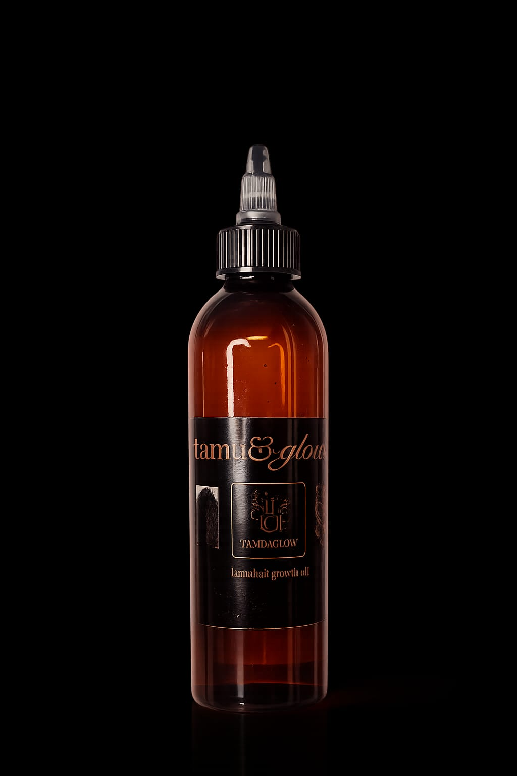 Tamu & Glow Hair Growth Oil large amber bottle with twist-cap applicator